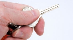 a hand holds a single key