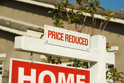 Price Reduced Real Estate Sign in Front of Beautiful New Home