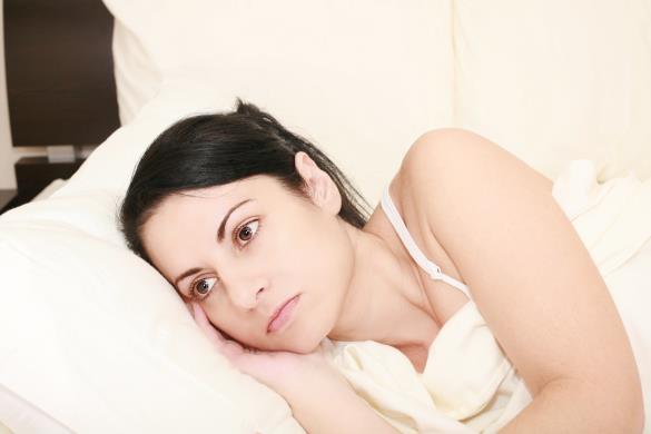Worried woman in the bed