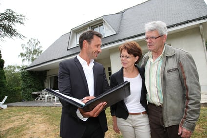 Real estate agent with senior couple buying new house