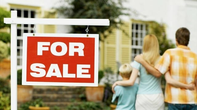 Two generation family looking at a house for sale