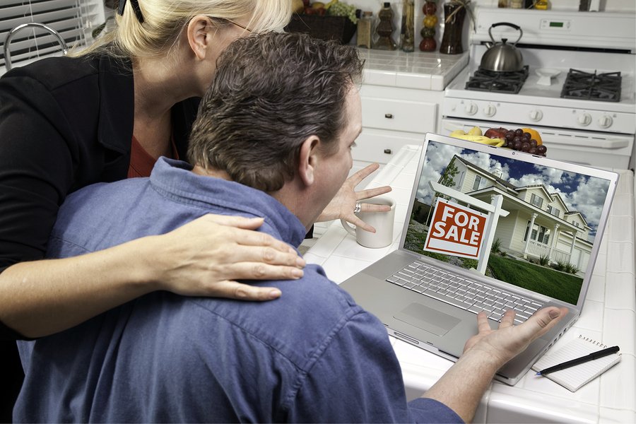 Couple In Kitchen Using Laptop to Research Real Estate Screen can be easily used for your own message or picture Picture on screen is my copyright as well