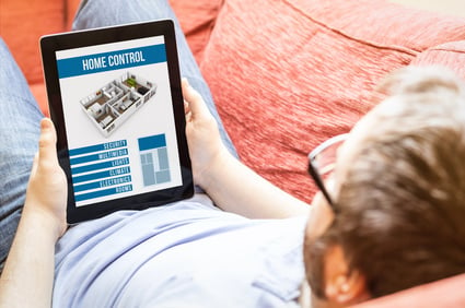 hipster on the sofa with smart home control tablet
