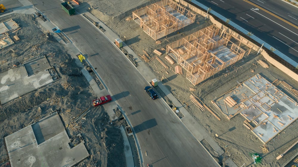 Drone Aerial View of Home Construction Site Foundations and Framing