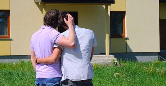 same sex couple embracing house 573x300