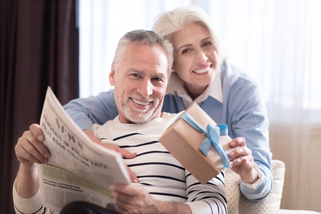 Cheerful aged couple relaxing at home