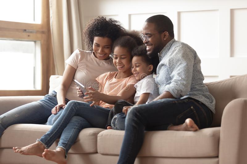 happy black family kids relax sofa tablet happy young black family preschooler children have fun relax together 161935700