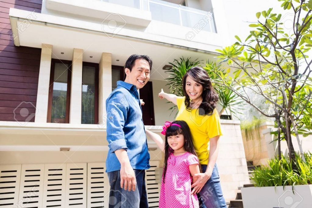 37802724 chinese family in front of house in residential area in asia