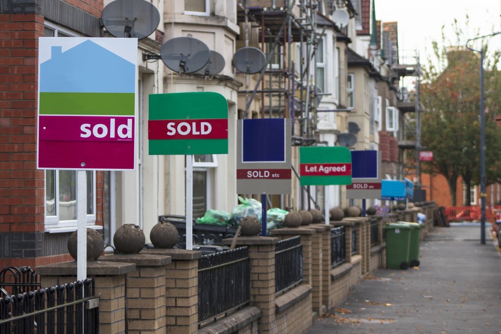 Property Sales Estate Agents Sold Signs on UK Terraced Houses