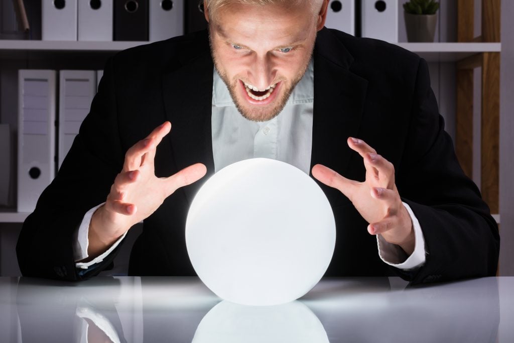 Businessman Looking Into The Future In A Crystal Ball