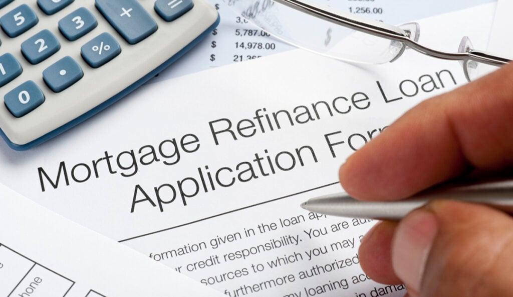 Mortgage Refinance Application Form with pen calculator writin